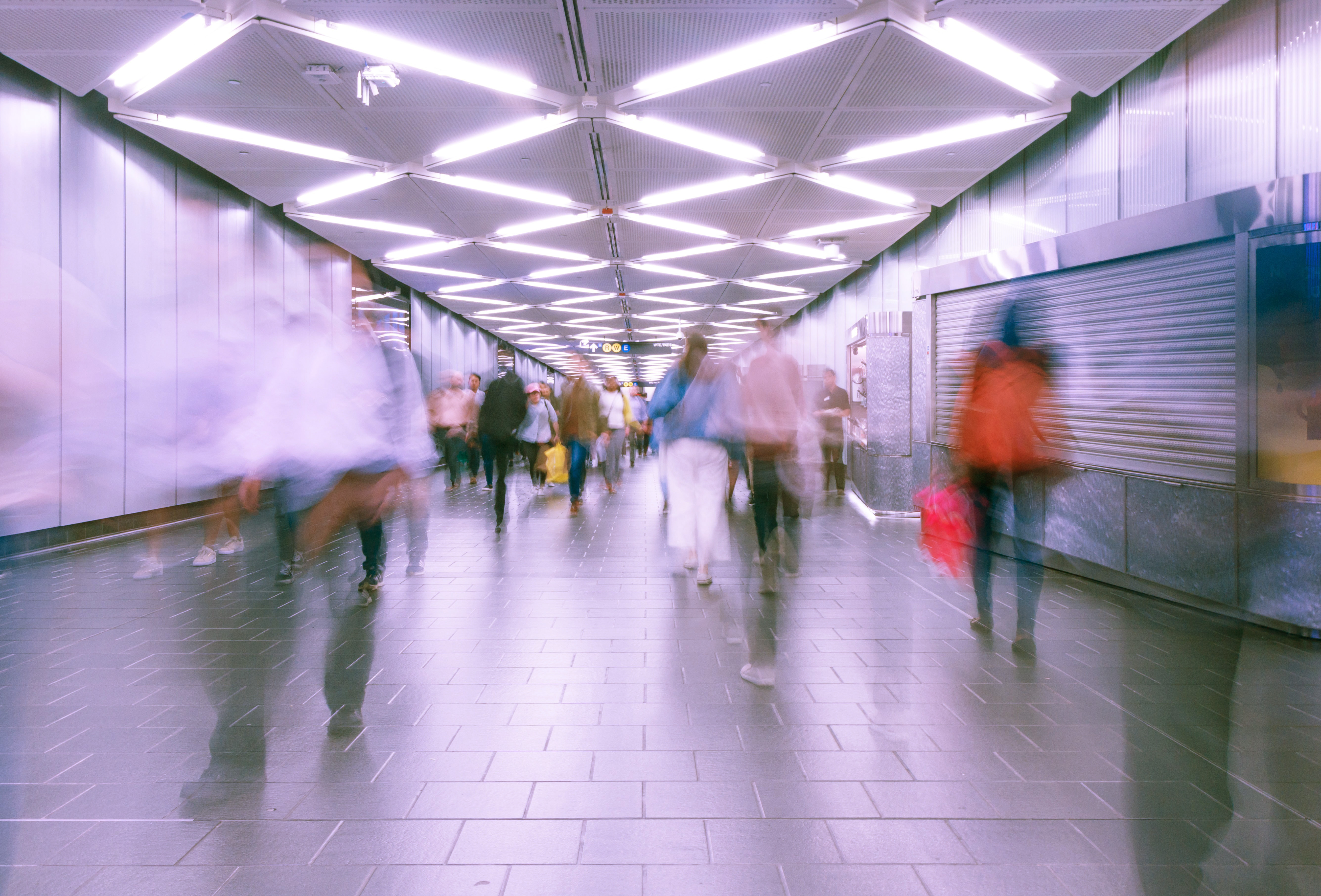 time lapse photograph of people walking in a NYC subway station