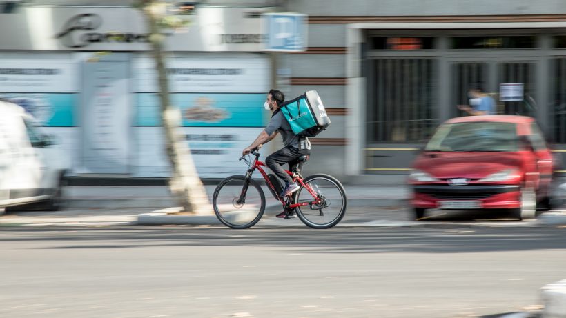 Food delivery worker riding a bike