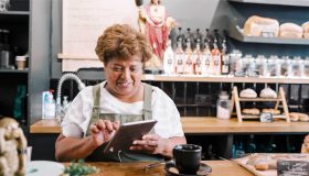 Business owner using iPad in retail store