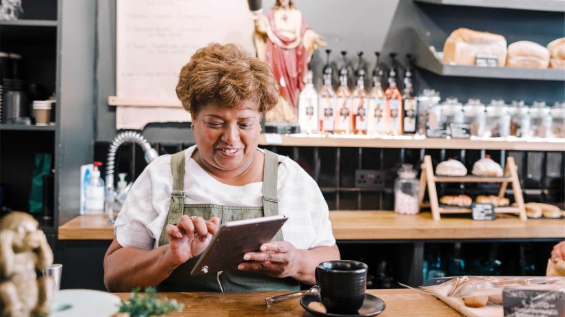 Business owner using iPad in retail store